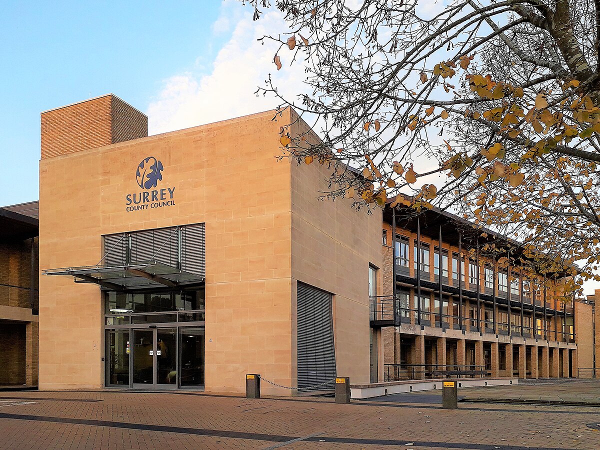 Surrey is launching a new form of local governance by piloting Neighbourhood Area Committees in three areas this July, ahead of a broader transition to a unitary council system. These committees will include members from county and local councils, police, health services, and the voluntary sector. The aim is to foster stronger community engagement and more efficient decision-making. The reform moves Surrey away from its current two-tier model, though the final structure—either two or three unitary councils—is still undecided. County-wide expansion of the pilot is expected this autumn, with community input playing a central role in the changes.