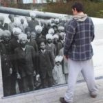 A man standing infront of banner