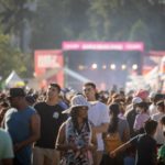 Large crowd enjoying a cultural festival in Surrey with tents, music, and performances.
