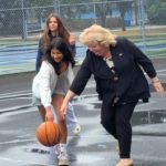 Mayor Brenda Locke playing basketball with Surrey youth during the launch of the city’s free self-service sports equipment program at a local park.