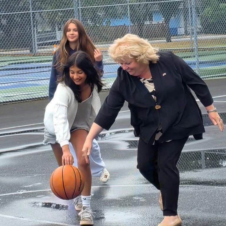 Mayor Brenda Locke playing basketball with Surrey youth during the launch of the city’s free self-service sports equipment program at a local park.