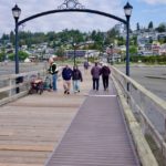Visitors walk along the White Rock Pier where new accessibility priority signs will be installed following council approval.