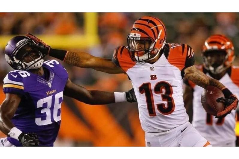 Rashaun Simonise in action during his professional football career before founding Wide Receiver University in Surrey.