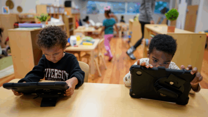 Children work on tablets