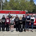 Firefighters Deliver Laptops to Local Students