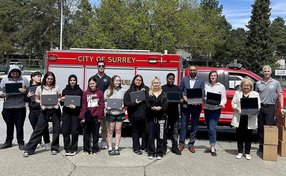 Firefighters Deliver Laptops to Local Students