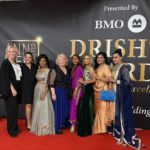 Group of guests posing on the red carpet at the 11th Drishti Awards Gala in Surrey, standing in front of the event backdrop presented by BMO.