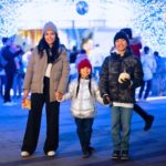 Surrey family enjoying the City of Surrey’s holiday light tunnel during winter festivities at Civic Plaza, photographed as part of Surrey’s seasonal events.
