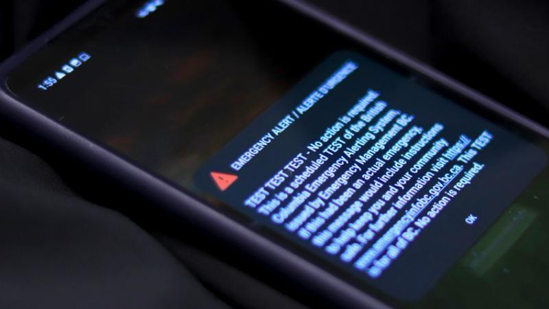 A BC Emergency Alert System test message displayed on a mobile phone during the province-wide alert scheduled for 1:55 p.m., shown as part of Surrey’s public safety coverage.