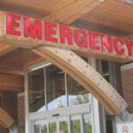 Entrance of a hospital emergency department in British Columbia, showing a red ‘Emergency’ sign above the doorway.