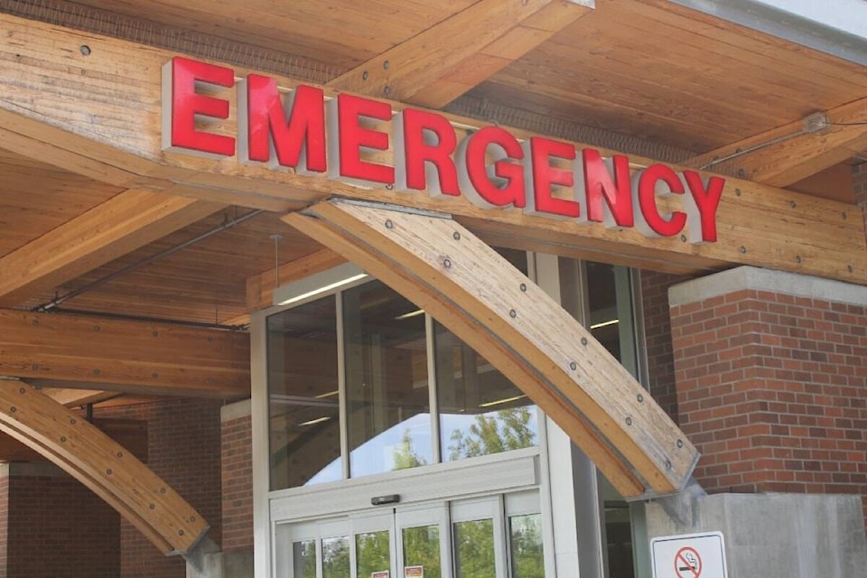 Entrance of a hospital emergency department in British Columbia, showing a red ‘Emergency’ sign above the doorway.