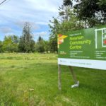 Sign marking the future home of the Newton Community Centre on the current PLOT community garden site in Surrey, captured for Surrey Speak’s coverage of the Newton Town Centre redevelopment plan.