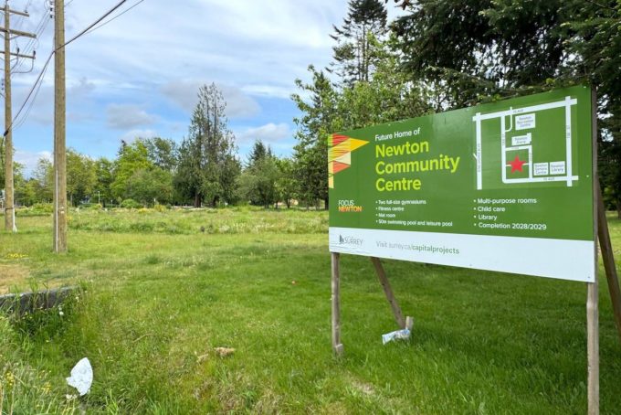 Sign marking the future home of the Newton Community Centre on the current PLOT community garden site in Surrey, captured for Surrey Speak’s coverage of the Newton Town Centre redevelopment plan.