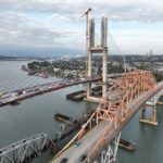 Aerial view of the new Pattullo Bridge replacement under construction beside the existing Pattullo Bridge over the Fraser River between Surrey and New Westminster.