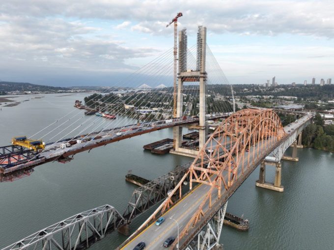 Aerial view of the new Pattullo Bridge replacement under construction beside the existing Pattullo Bridge over the Fraser River between Surrey and New Westminster.
