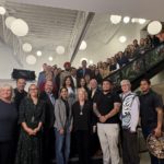 Large group photo at the Foundry Surrey Central opening event, with a civic leader standing at the center among community members, staff, and supporters.