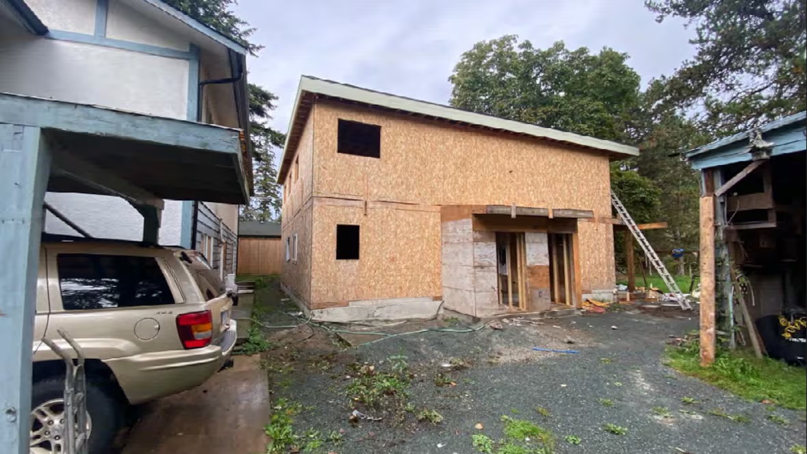 Two-storey wooden structure in Surrey built without permits, photographed during construction before council issued a notice on title.