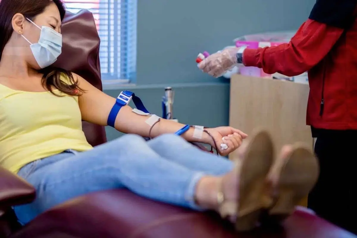 A woman donates at a Canadian Blood Services clinic.