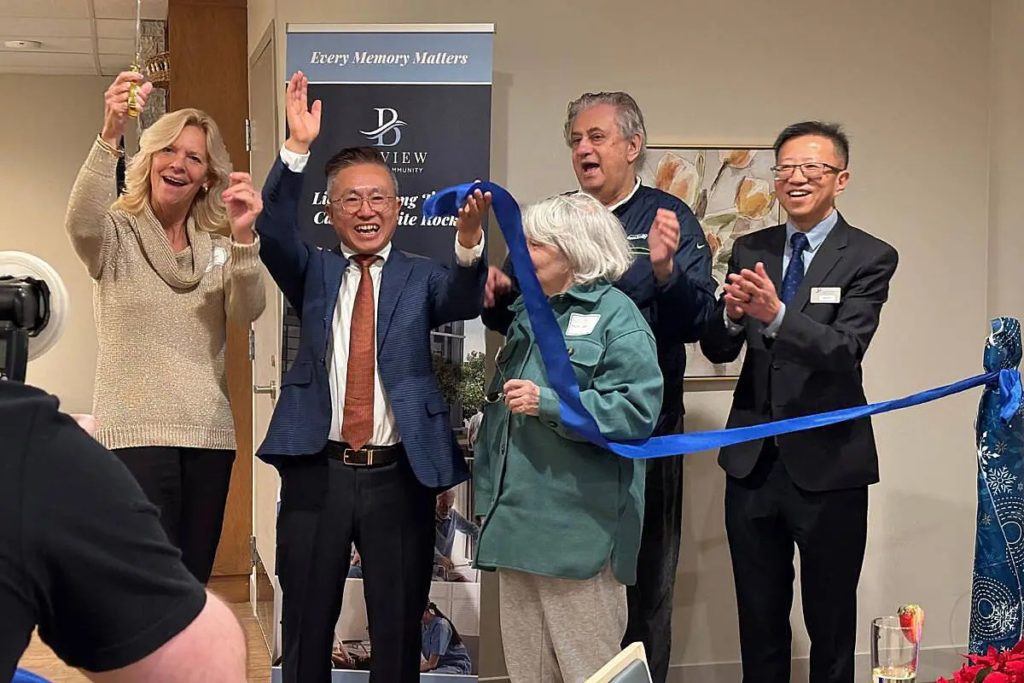 White Rock Mayor Megan Knight raises a toast and joins Bayview staff and the first resident during the ribbon‑cutting ceremony for Bayview Seniors Community. (Grace McLeod / Peace Arch News)