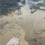 Aerial view of flooded farmland and roads in Abbotsford, showing extensive high water across fields and infrastructure.
