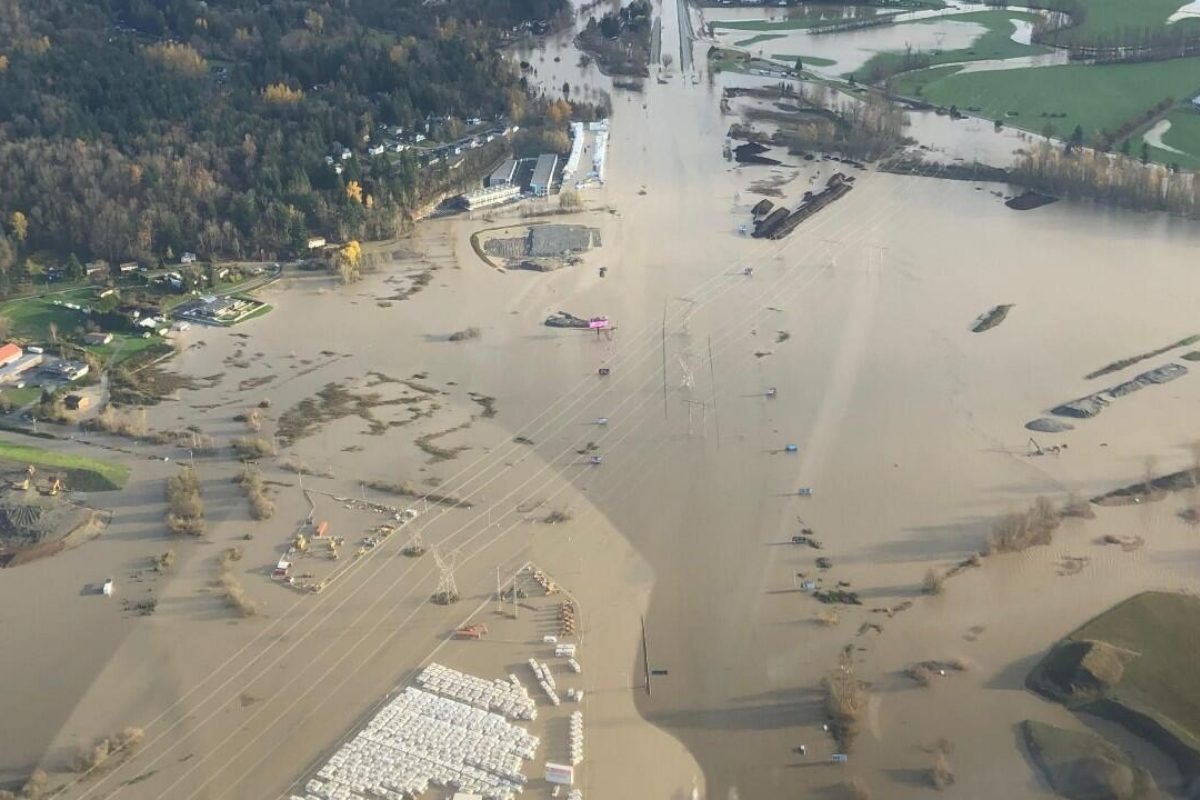 Aerial view of flooded farmland and roads in Abbotsford, showing extensive high water across fields and infrastructure.