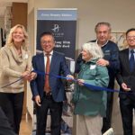 Officials and the first resident cut a blue ribbon during the opening ceremony for Bayview Seniors Community in White Rock.