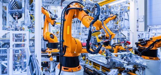 Industrial robots working on an advanced manufacturing line, symbolizing B.C.’s Look West innovation funding for new technologies.