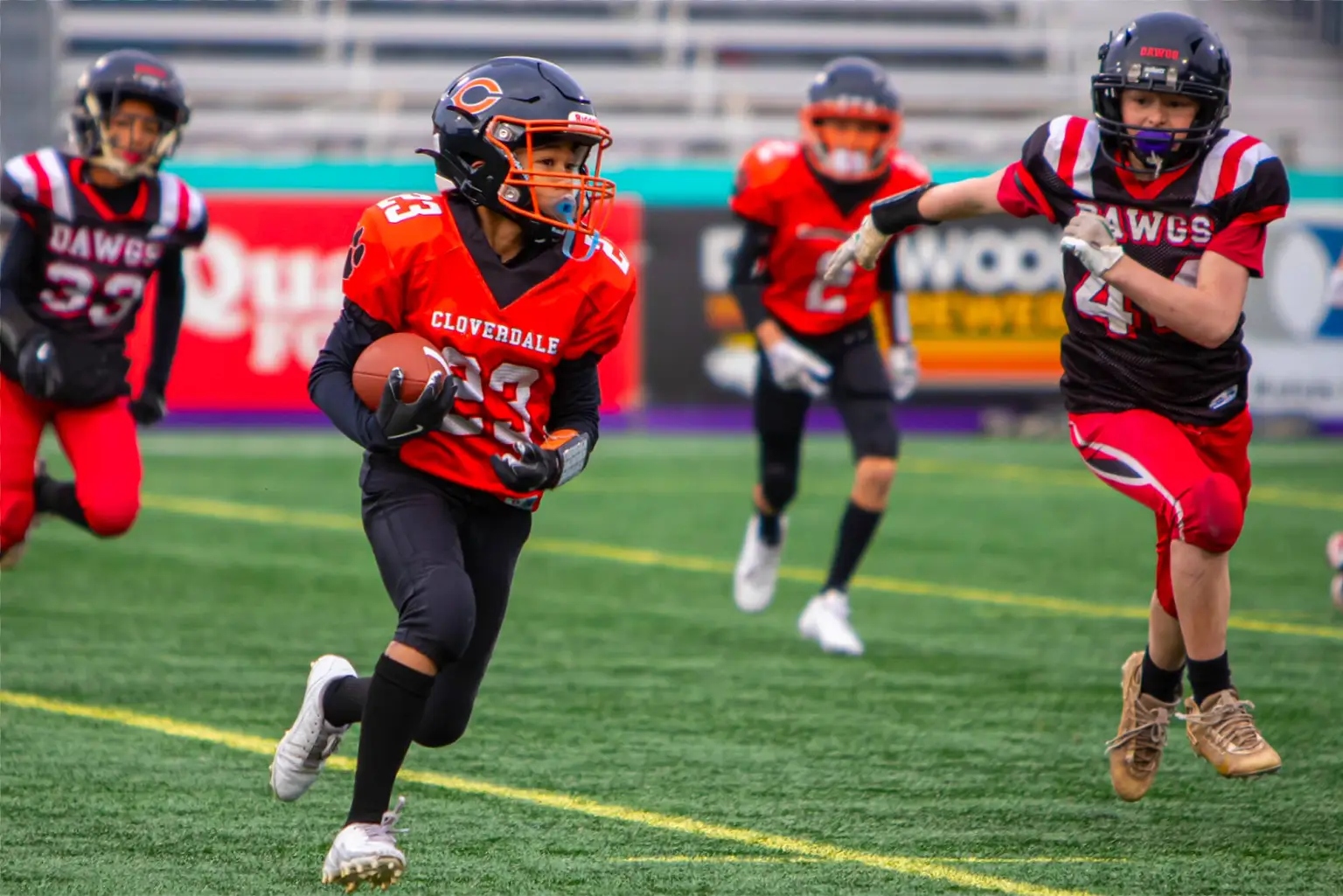 Cloverdale U12 Bobcats running back carries the football past a Southside Dawgs defender during the provincial championship game.