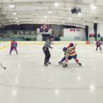 Cloverdale Hockey Club and Aldergrove Ironmen players battle for the puck during a faceoff in a PJHL game at Cloverdale Arena.