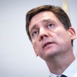 Close-up of B.C. Premier David Eby speaking at a news conference, with a neutral background.