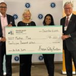 Four people hold an oversized cheque for Mackie’s Place at a Fraser Valley Realtors Charitable Foundation grant ceremony in Surrey.