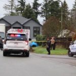 Police and emergency vehicles block a residential street in Surrey’s Newton neighbourhood after a serious collision involving a child and a large cube van.