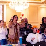 Fans cheer and react during a live fighting-game match at the Pataka E-sports Festival, capturing the energy of the event.