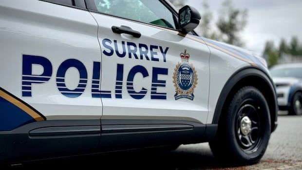 Surrey RCMP police vehicle investigates three shots fired at Guildford residence, RCMP SPOSU leads probe.