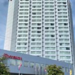 Exterior view of the Sheraton Vancouver Guildford Hotel tower in Surrey on a clear day.