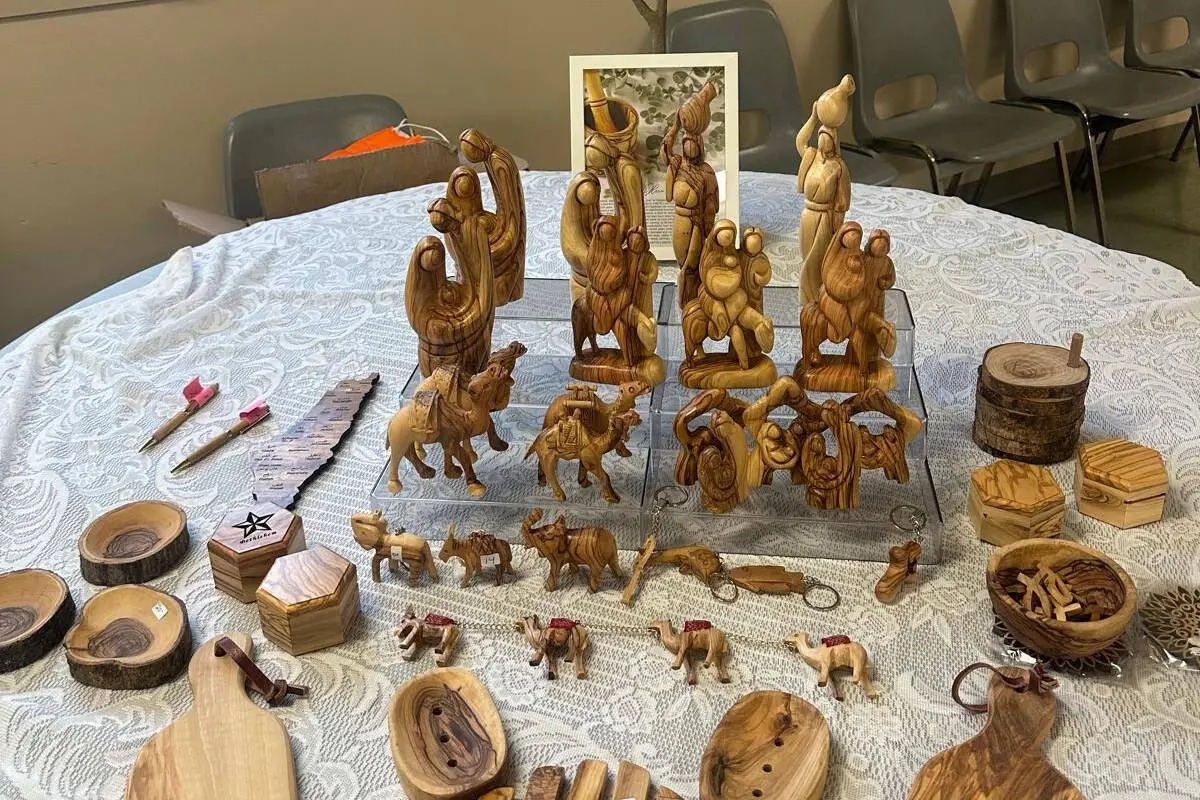 Olive-wood nativity figures, camels and small carvings from Palestinian artisans displayed on a table at a South Surrey craft fair fundraiser.