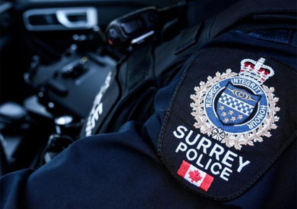 Close-up of a Surrey Police Service uniform patch inside a patrol vehicle, representing officers responding to a serious collision in Newton.
