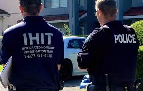 IHIT investigators and Surrey police officers standing near a residential crime scene in Surrey, B.C.