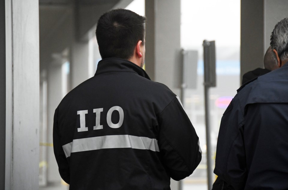 IIO investigator wearing a jacket marked “IIO” at an incident scene