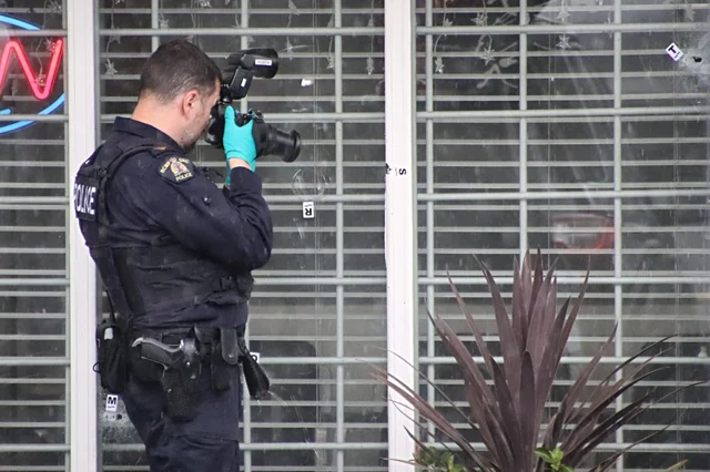 Police man taking pictures of fired marks