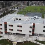Aerial view of Snokomish Elementary, Surrey's first three-storey school with courtyard, playground and playing fields in Panorama neighbourhood