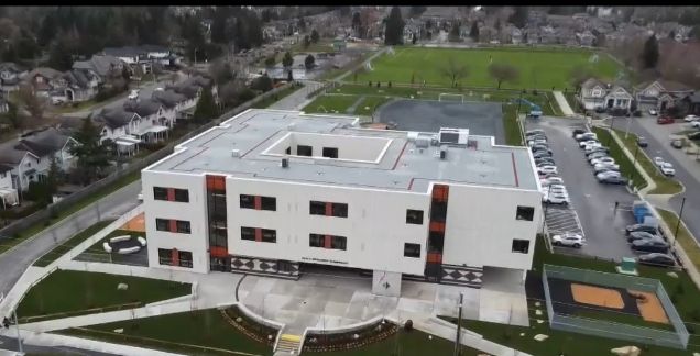 Aerial view of Snokomish Elementary, Surrey's first three-storey school with courtyard, playground and playing fields in Panorama neighbourhood