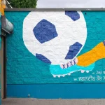 Section of a new “Community in Bloom” mural by visual artist Jag Nagra on the washroom/community room building at Newton Athletic Park in Surrey
