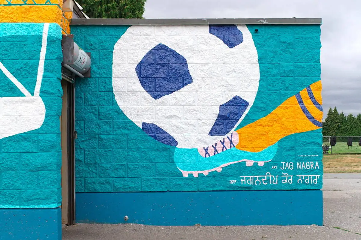 Section of a new “Community in Bloom” mural by visual artist Jag Nagra on the washroom/community room building at Newton Athletic Park in Surrey