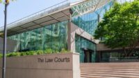Exterior view of the British Columbia Law Courts building in Vancouver, featuring glass architecture and courthouse entrance