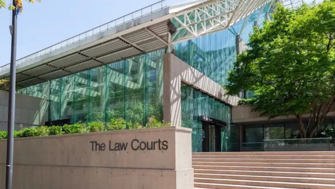 Exterior view of the British Columbia Law Courts building in Vancouver, featuring glass architecture and courthouse entrance