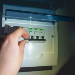 A homeowner checking an electrical breaker during a planned power outage in Richmond, B.C.