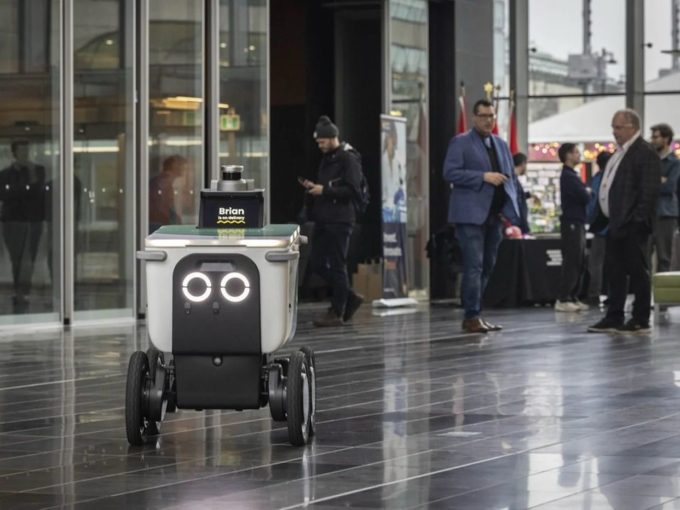 Screenshot of a City of Surrey social media post showing an autonomous food delivery robot demonstration at Surrey City Hall.
