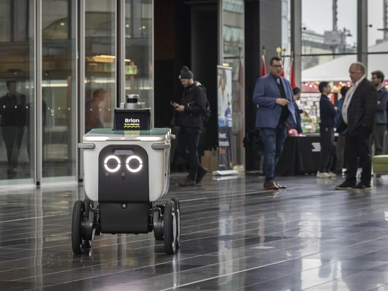 Screenshot of a City of Surrey social media post showing an autonomous food delivery robot demonstration at Surrey City Hall.