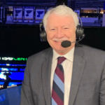 John Garrett Vancouver Canucks broadcaster smiling during a hockey broadcast